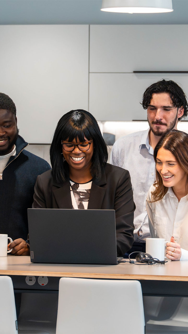 Audit team reviewing client accounts on a laptop.